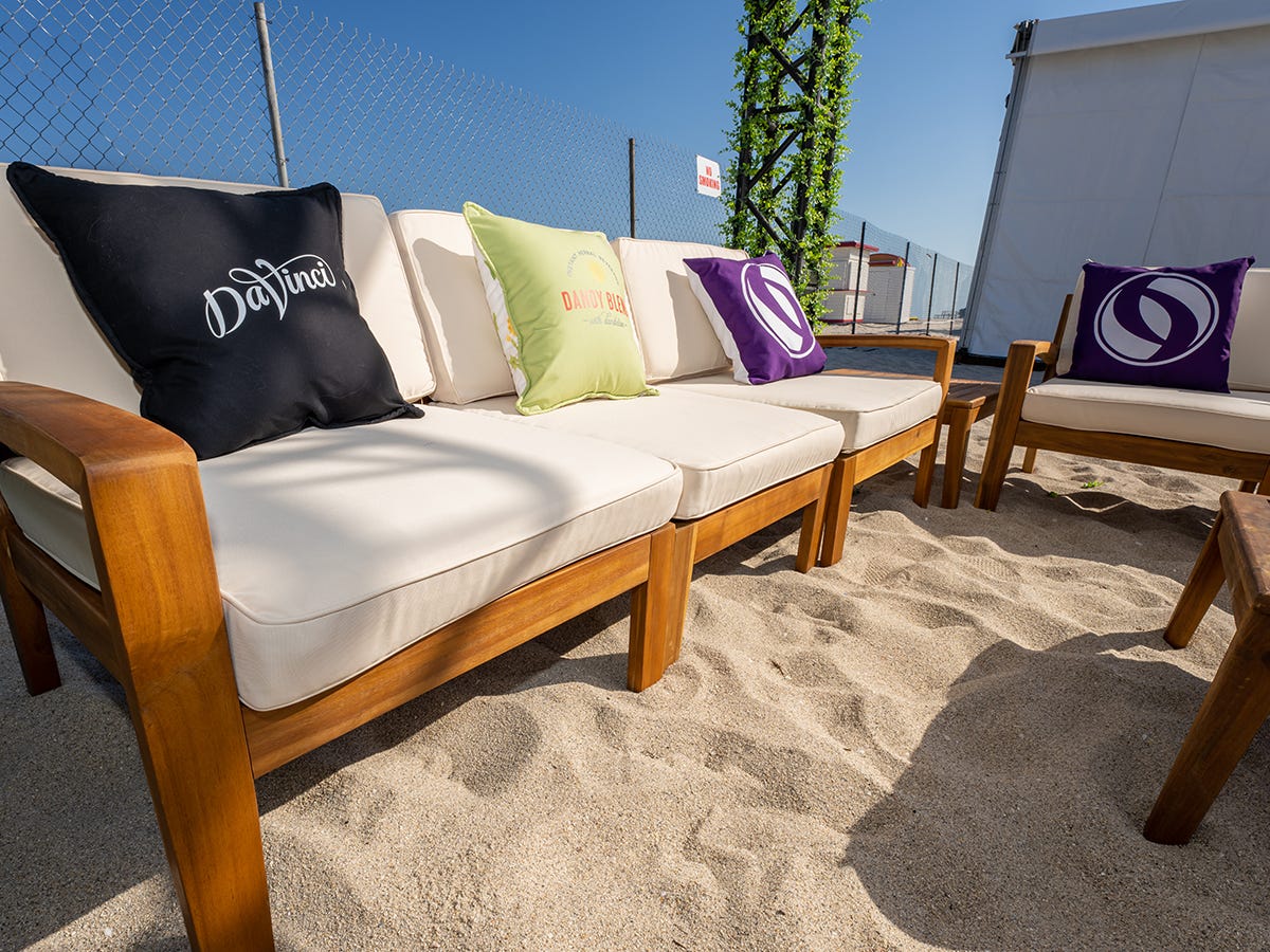 Custom Printed Pillows on an outdoor sofa in an event lounge on the beach