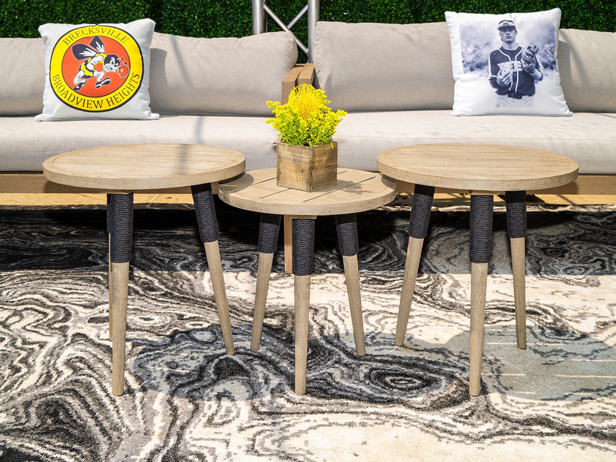 Graduation party lounge area with custom printed pillows showing the graduate and his high school logo